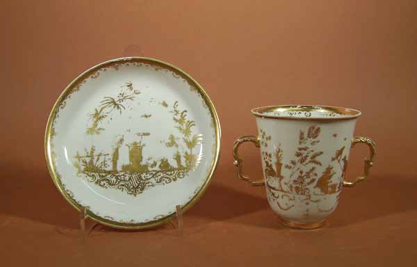 two handled cup and saucer